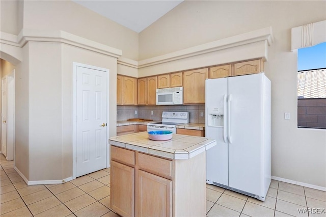 kitchen featuring white appliances, light tile patterned floors, arched walkways, tile countertops, and a kitchen island