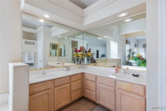 full bath with double vanity, a sink, and recessed lighting