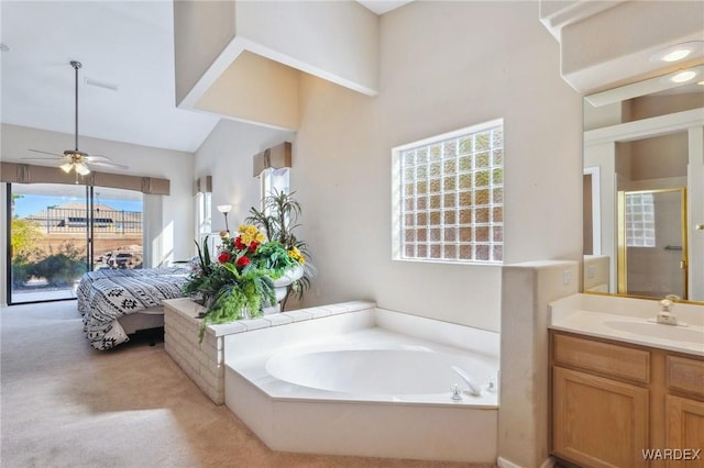 ensuite bathroom with a garden tub, connected bathroom, vanity, a ceiling fan, and a shower with door