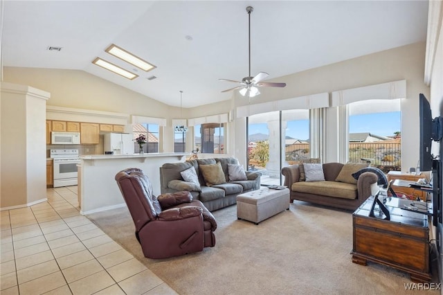 living area with light tile patterned floors, lofted ceiling, visible vents, light colored carpet, and a ceiling fan