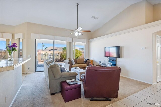 living area featuring light tile patterned floors, visible vents, light colored carpet, ceiling fan, and high vaulted ceiling