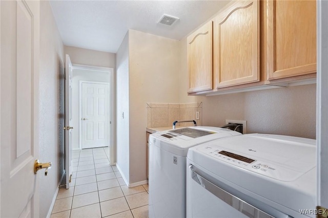 laundry area with cabinet space, visible vents, baseboards, washing machine and dryer, and light tile patterned flooring