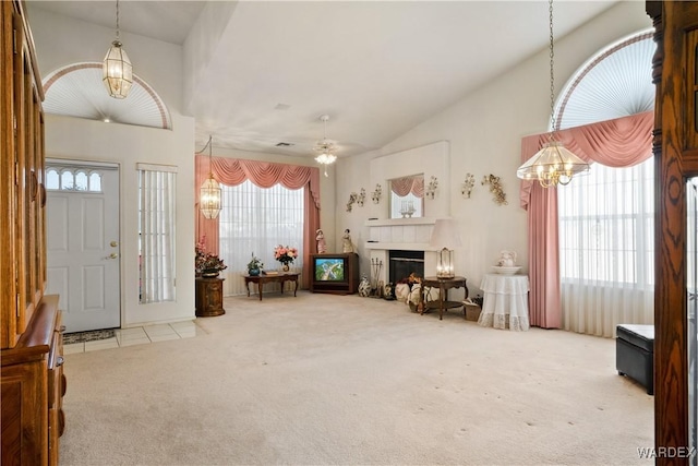 5790 S Gazelle Dr, Fort Mohave, AZ 86426 - entrance foyer featuring a fireplace, carpet flooring, a notable chandelier, and lofted ceiling