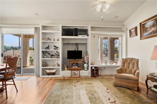 5790 S Gazelle Dr, Fort Mohave, AZ 86426 - living area with a wealth of natural light, a ceiling fan, and wood finished floors