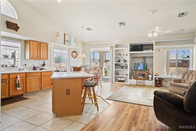 5790 S Gazelle Dr, Fort Mohave, AZ 86426 - kitchen with open floor plan, a breakfast bar area, and visible vents