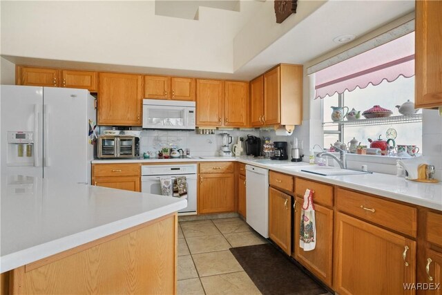 5790 S Gazelle Dr, Fort Mohave, AZ 86426 - kitchen with tasteful backsplash, light tile patterned floors, a sink, light countertops, and white appliances