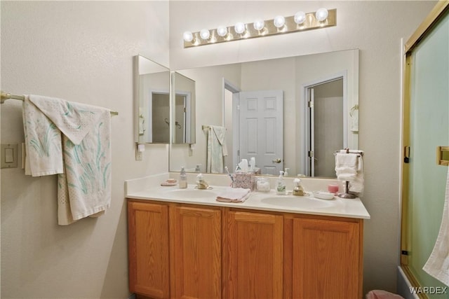 5790 S Gazelle Dr, Fort Mohave, AZ 86426 - full bathroom with an enclosed shower, double vanity, and a sink