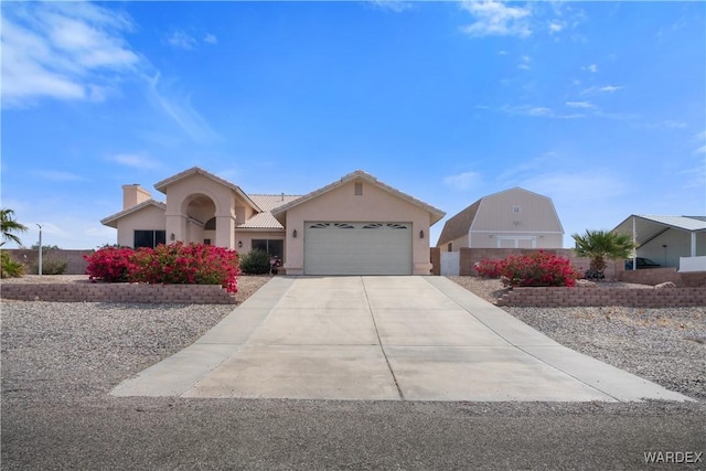 5790 S Gazelle Dr, Fort Mohave, AZ 86426 - ranch-style house with stucco siding, a tile roof, a chimney, a garage, and driveway