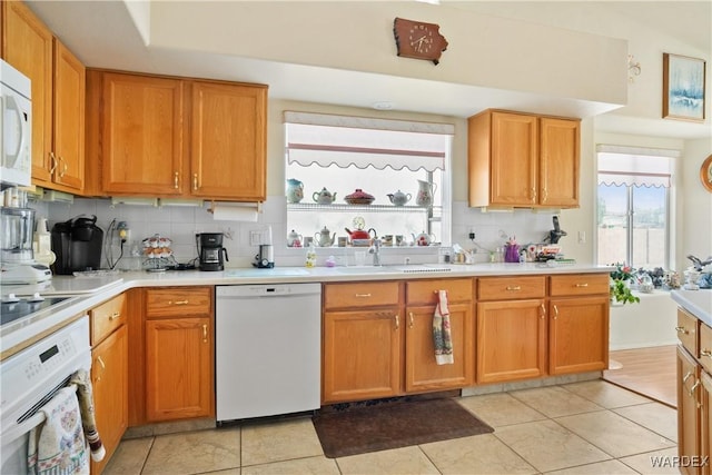 5790 S Gazelle Dr, Fort Mohave, AZ 86426 - kitchen with plenty of natural light, a sink, light countertops, white appliances, and backsplash