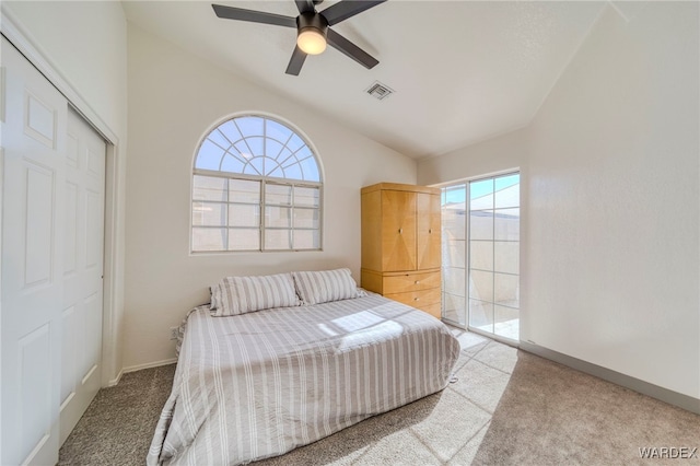 carpeted bedroom featuring baseboards, visible vents, ceiling fan, and a closet