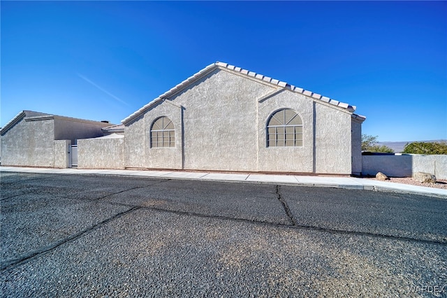 view of side of home with stucco siding