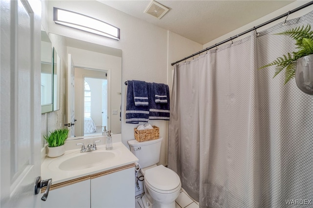 ensuite bathroom with toilet, visible vents, ensuite bathroom, and vanity