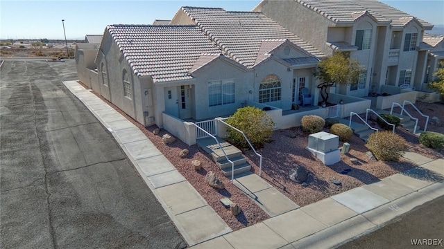 view of front of property with a tile roof and stucco siding