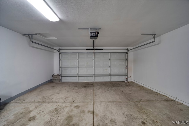 garage featuring baseboards and a garage door opener