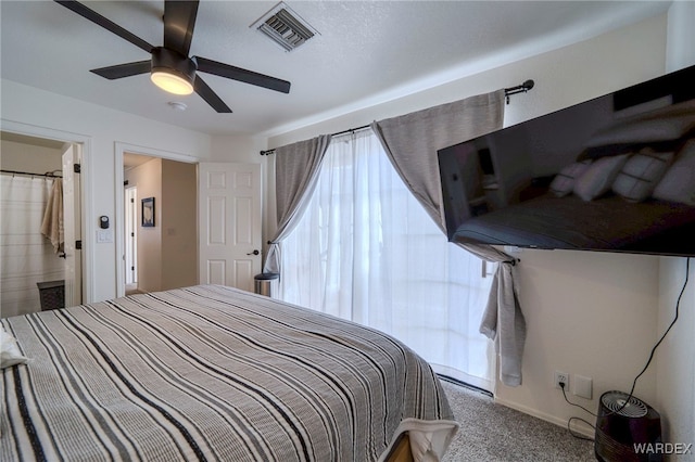 carpeted bedroom with visible vents and a ceiling fan