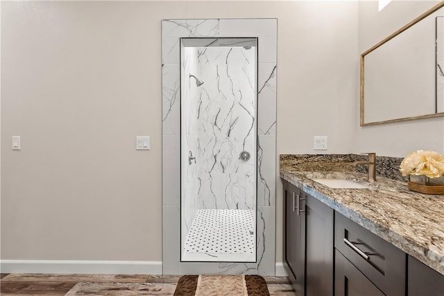 6183 S Lago Grande Dr, Fort Mohave, AZ 86426 - bathroom with a marble finish shower, vanity, baseboards, and wood finished floors