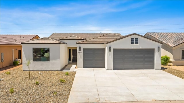 6183 S Lago Grande Dr, Fort Mohave, AZ 86426 - view of front of house featuring a garage, stucco siding, concrete driveway, and a tile roof