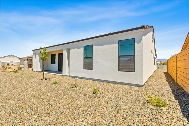 6183 S Lago Grande Dr, Fort Mohave, AZ 86426 - rear view of house featuring stucco siding