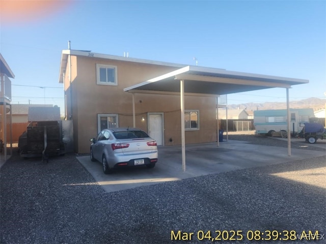 view of vehicle parking with an attached carport