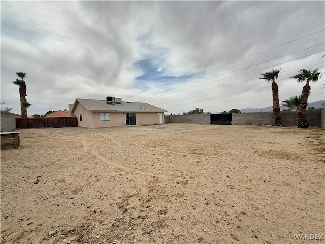 view of yard featuring central AC unit and fence