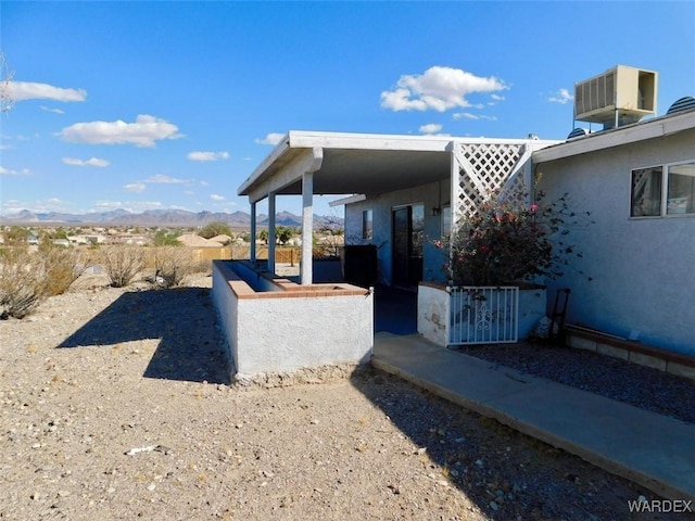 exterior space featuring cooling unit and a mountain view