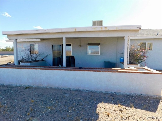 back of house with stucco siding