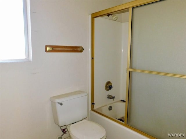 full bath featuring toilet and bath / shower combo with glass door