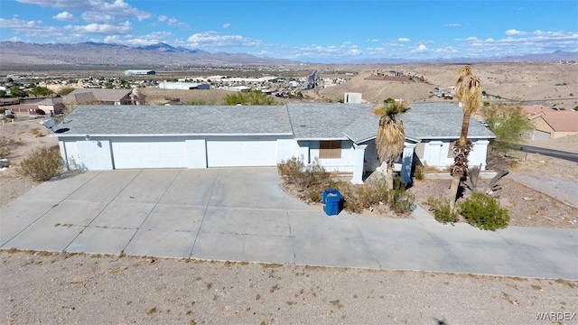 view of front of home featuring a garage, driveway, and a mountain view