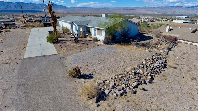 view of front of home with concrete driveway and a mountain view