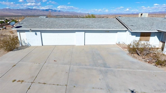 garage featuring driveway and a mountain view