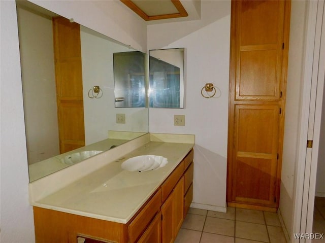 bathroom featuring baseboards, vanity, and tile patterned floors