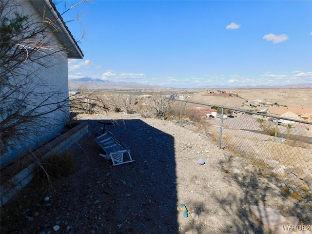 view of yard with fence and a mountain view