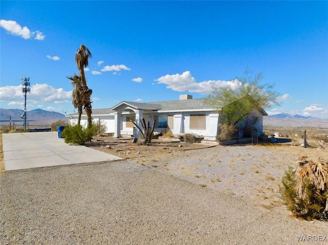 ranch-style house featuring a mountain view and driveway