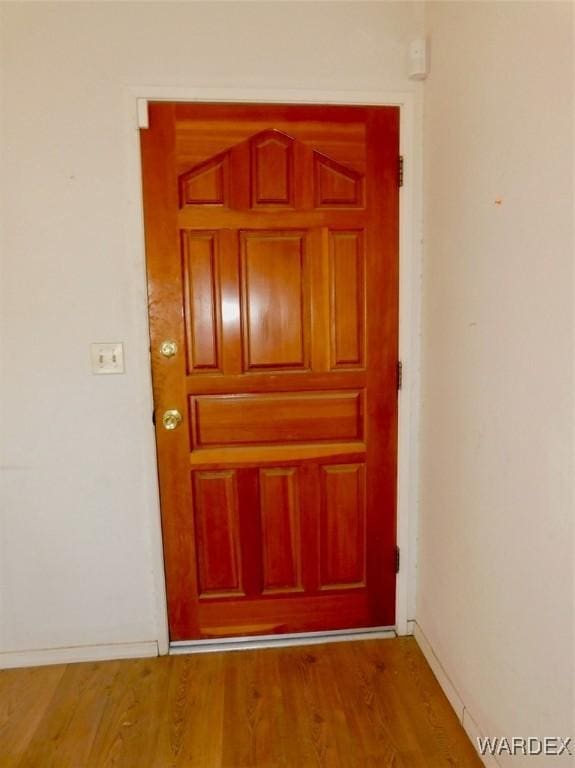 interior space with wood finished floors and baseboards