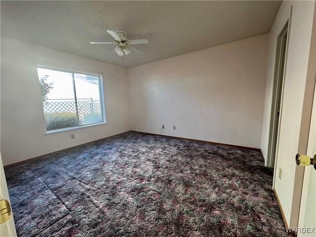 empty room featuring baseboards, a ceiling fan, carpet, and a textured ceiling