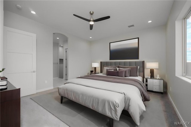 bedroom with arched walkways, baseboards, and recessed lighting