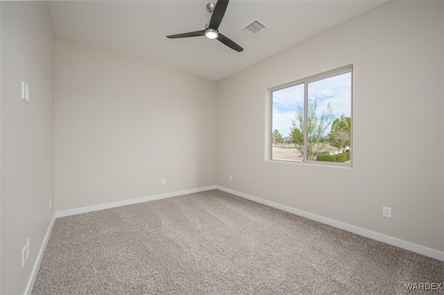 spare room featuring a ceiling fan, carpet, visible vents, and baseboards