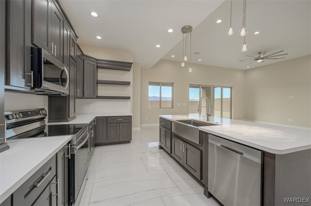 kitchen featuring stainless steel appliances, light countertops, a sink, and open shelves