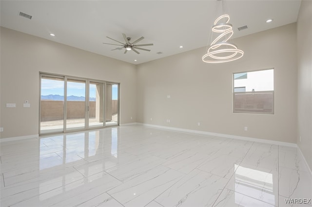 empty room with marble finish floor, recessed lighting, visible vents, baseboards, and ceiling fan with notable chandelier