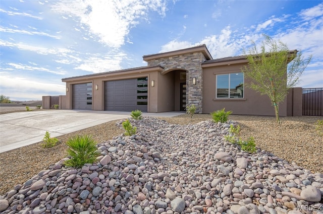 view of front of house with stone siding, concrete driveway, a garage, and stucco siding