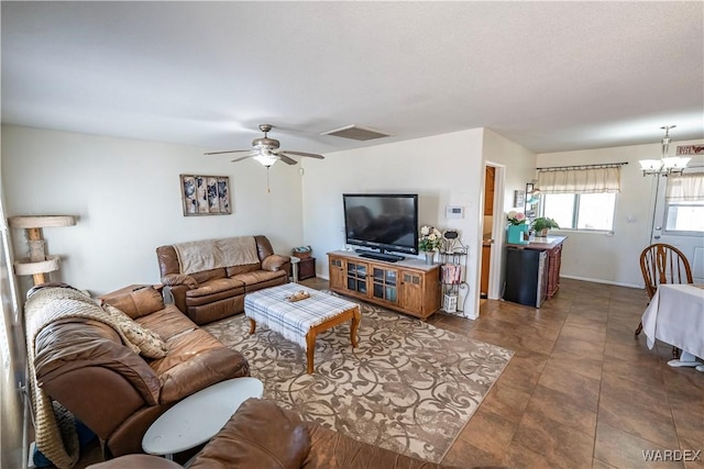 living room with visible vents and ceiling fan with notable chandelier