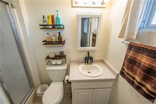 bathroom featuring a shower stall, vanity, and toilet