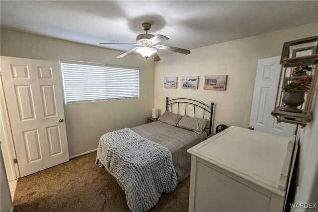 bedroom with dark colored carpet and a ceiling fan