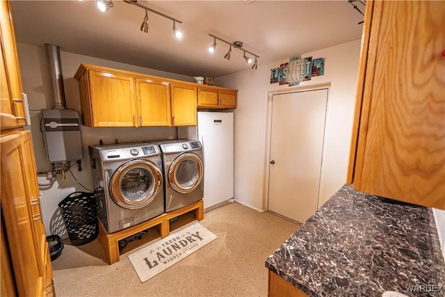 washroom featuring washer and clothes dryer and cabinet space