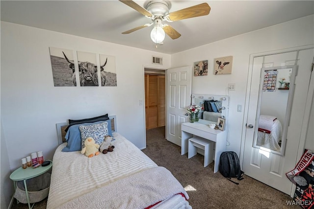 carpeted bedroom featuring ceiling fan and visible vents