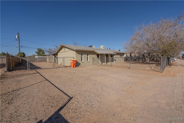 rear view of property featuring fence private yard and a gate