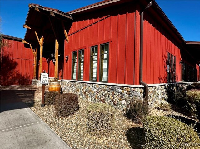 view of property exterior with stone siding