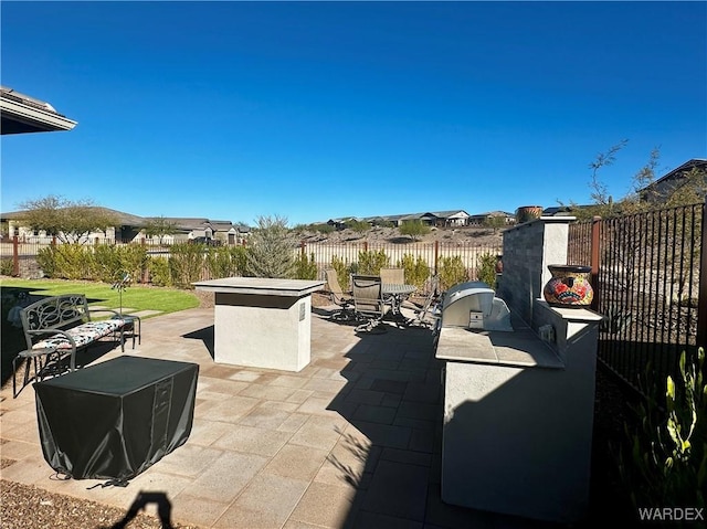 view of patio featuring area for grilling and fence