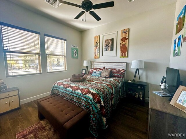 bedroom with baseboards, visible vents, ceiling fan, and wood finished floors