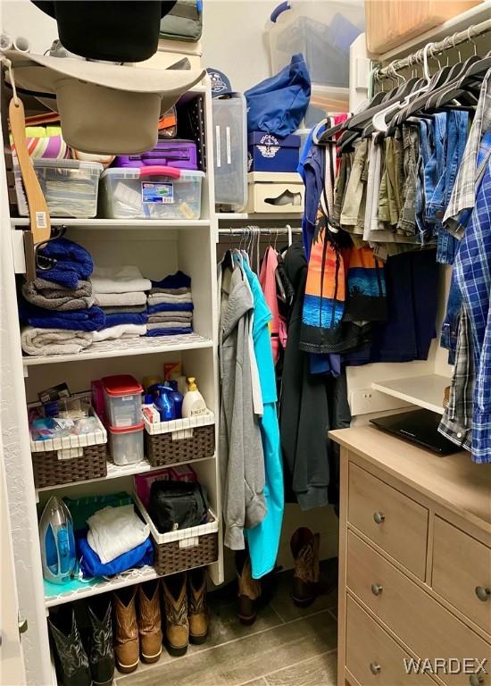 walk in closet featuring wood finished floors